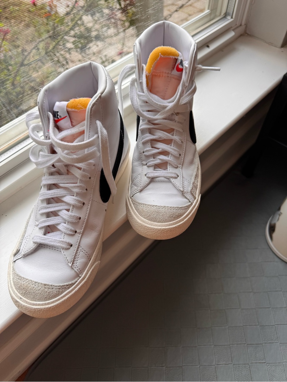 Nike White High-Top Sneakers with Black Swoosh and Orange Tongue